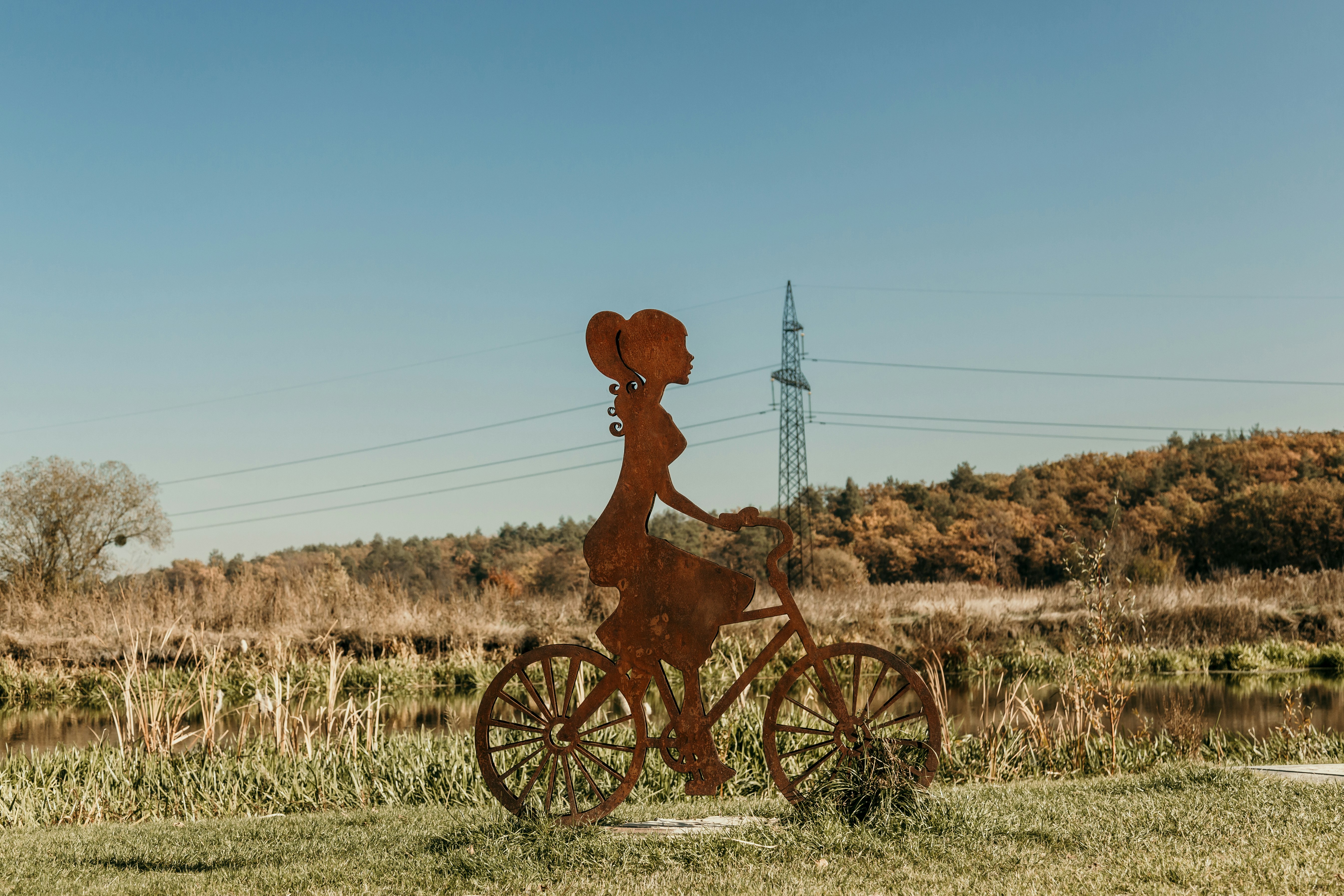 woman riding bike standee on grass during day